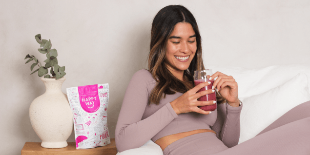 Woman drinking Happy Way protein powder